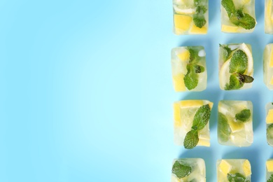 Flat lay composition with lemon and mint ice cubes on color background. Space for text