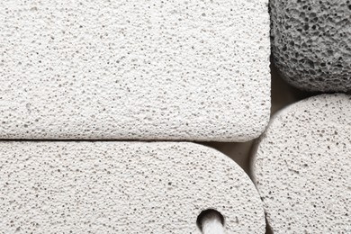 Photo of Different pumice stones on light background, flat lay. Pedicure tool