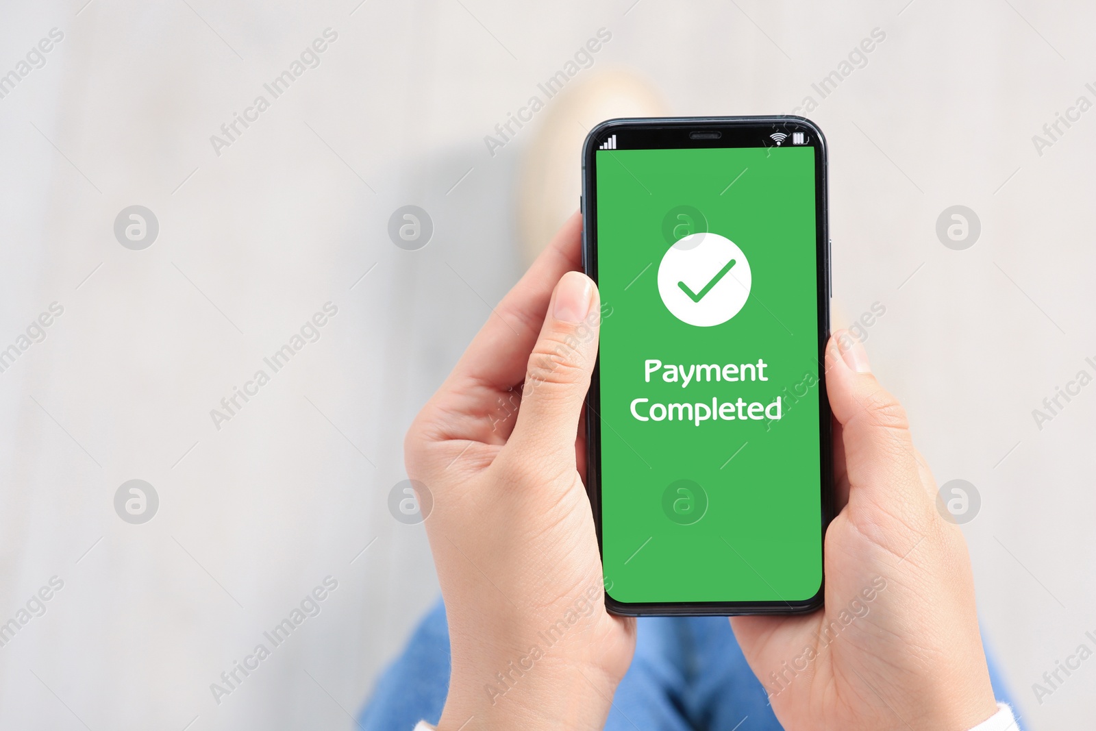 Image of Woman successfully made payment using online banking application on smartphone indoors, closeup