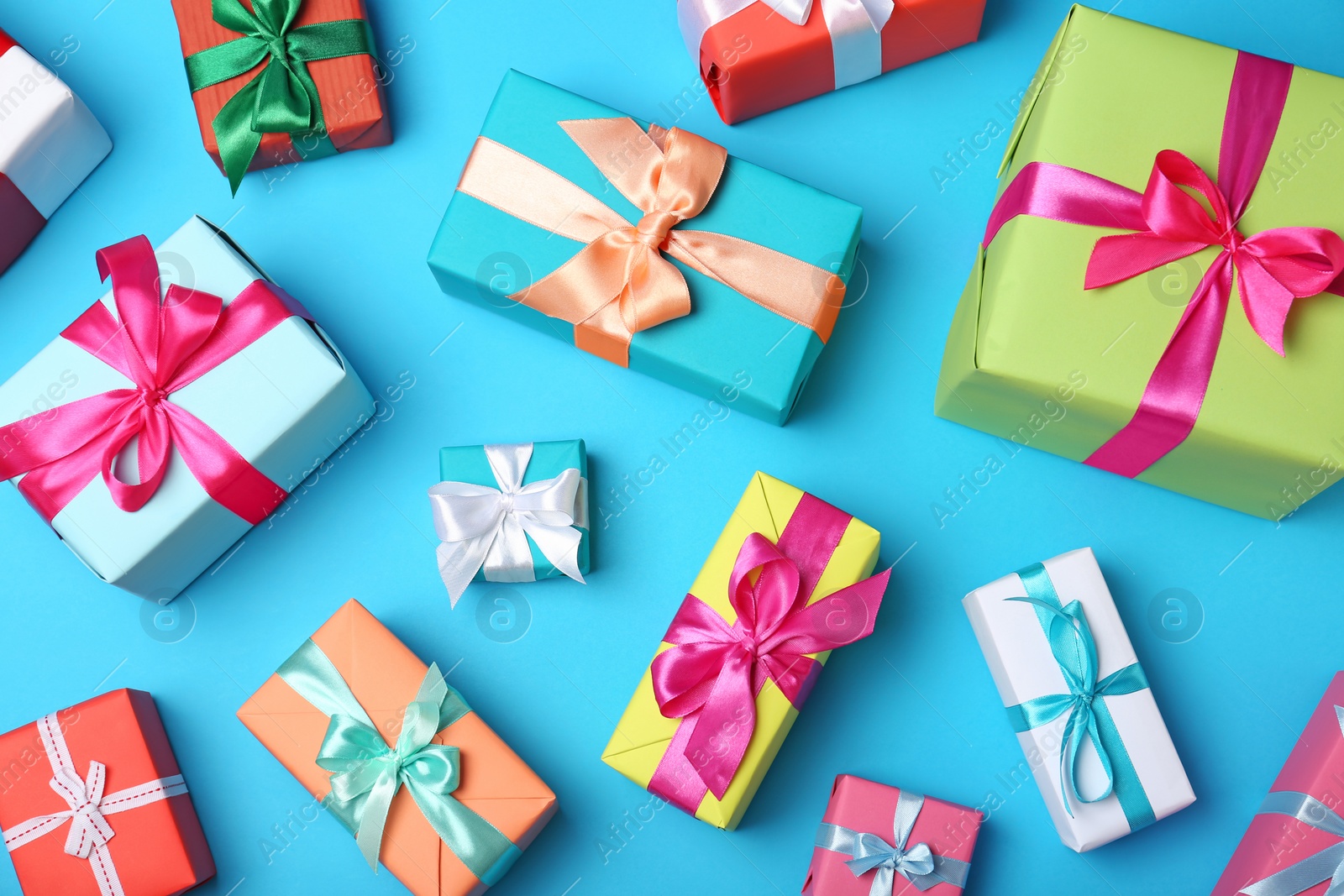 Photo of Flat lay composition with beautiful gift boxes on color background