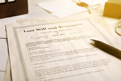 Image of Last Will and Testament with pen on table, closeup