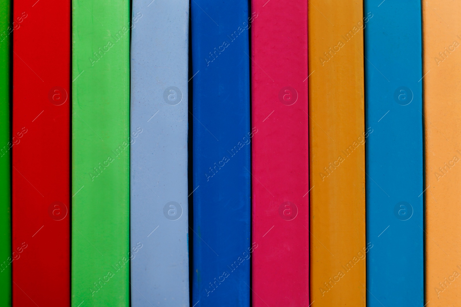 Photo of Set of colorful pastels as background, closeup. Drawing materials