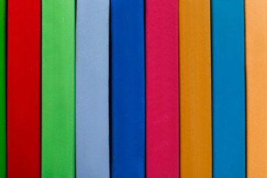 Photo of Set of colorful pastels as background, closeup. Drawing materials