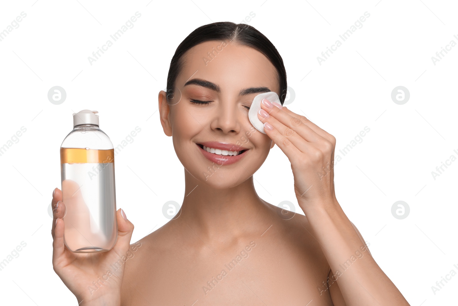 Photo of Beautiful woman removing makeup with cotton pad on white background