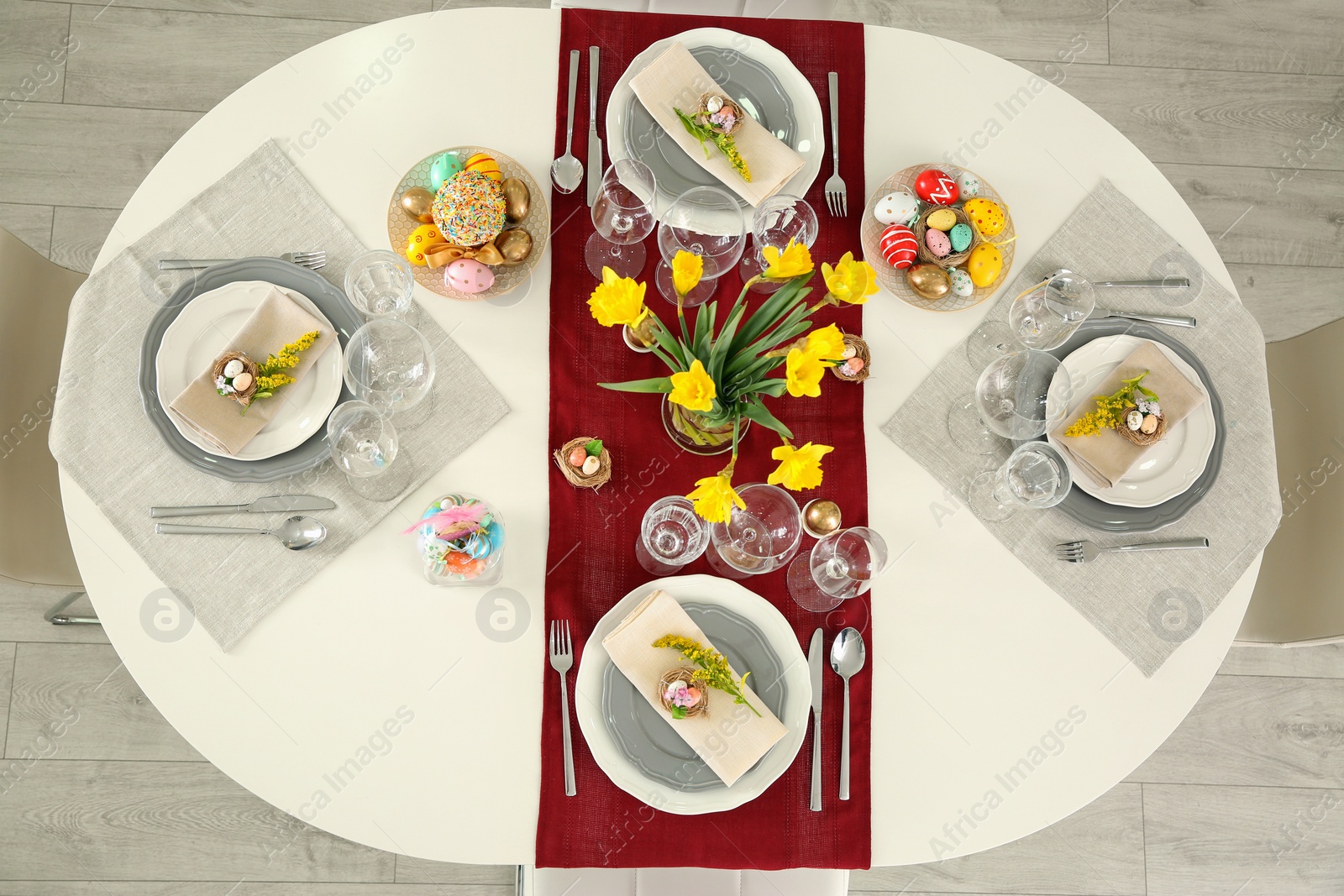 Photo of Festive Easter table setting with floral decor, flat lay