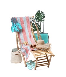 Photo of Deck chair, suitcase and beach accessories isolated on white