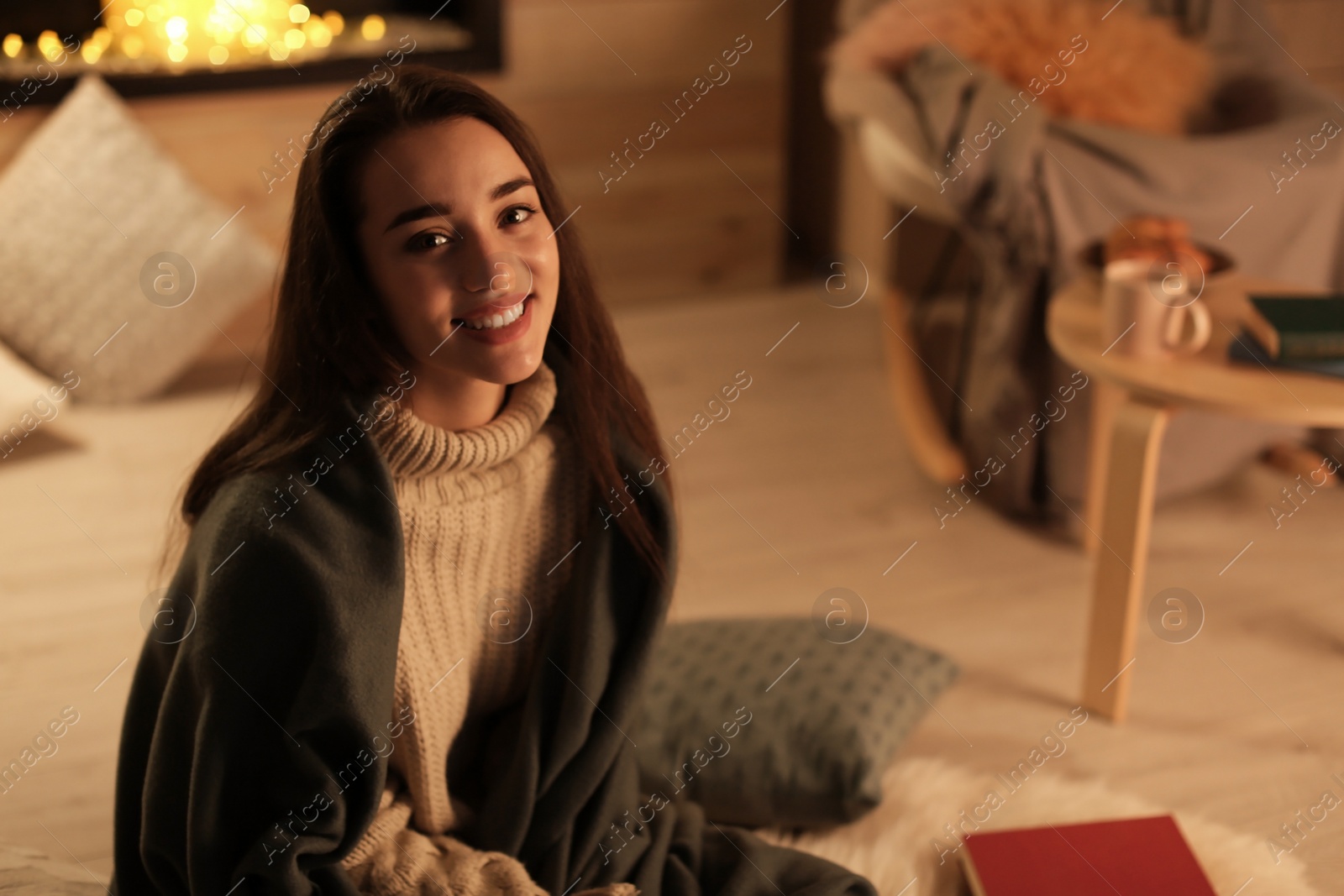 Photo of Young pretty woman with plaid resting at home. Winter season