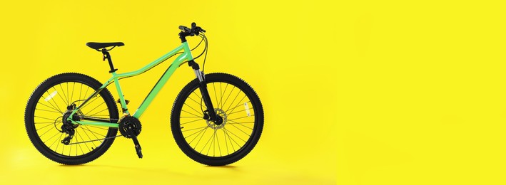 Image of Modern bicycle on yellow background, space for text. Banner design