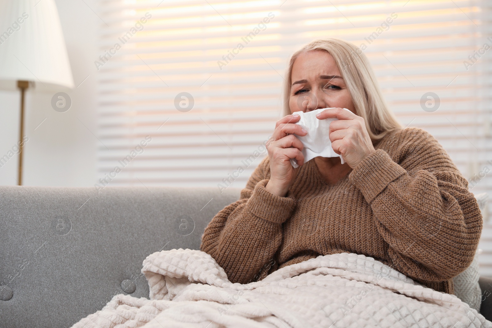 Photo of Mature woman suffering from cold at home. Dangerous virus