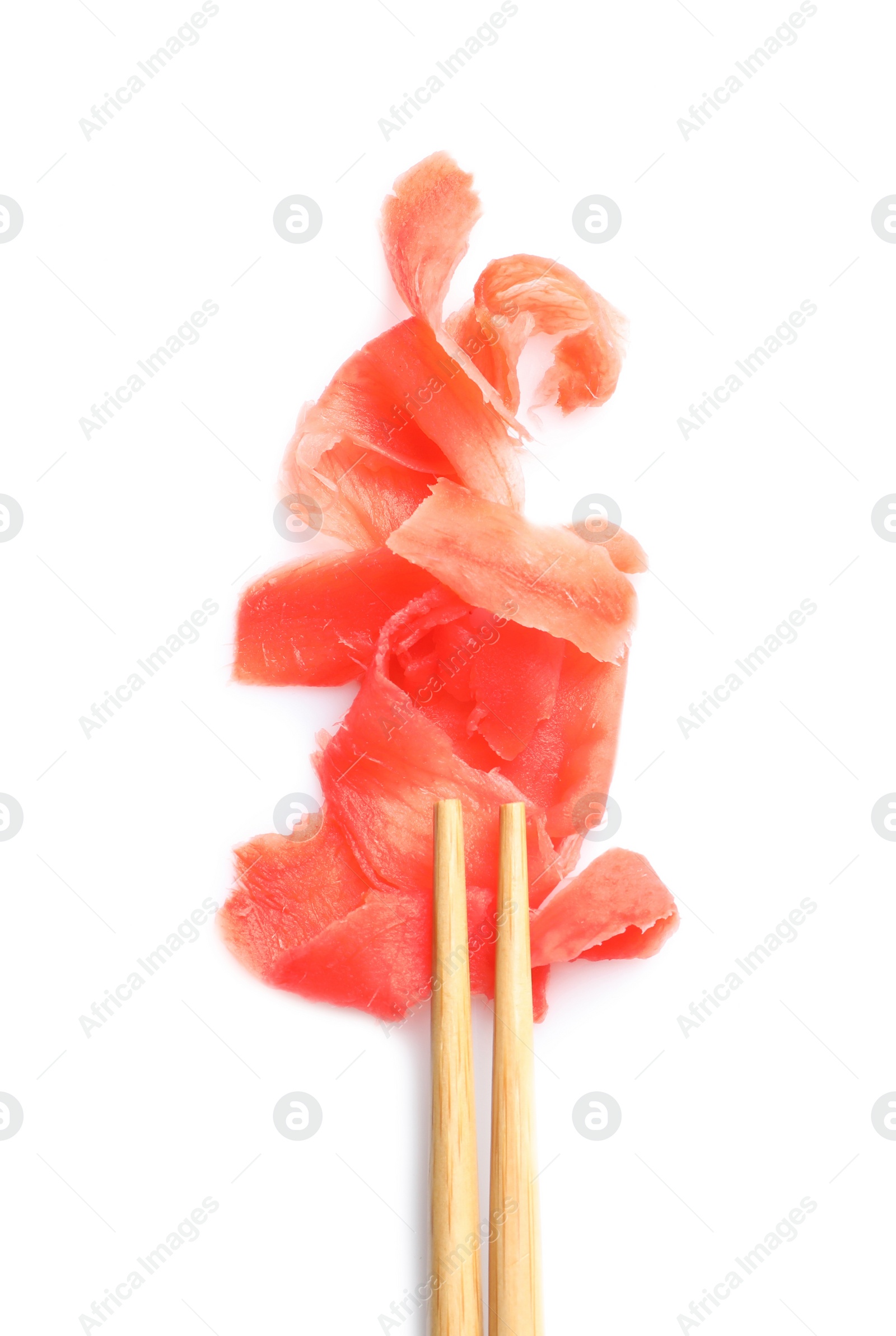 Photo of Piquant pickled ginger and chopsticks on white background, top view. Delicious sauce condiment