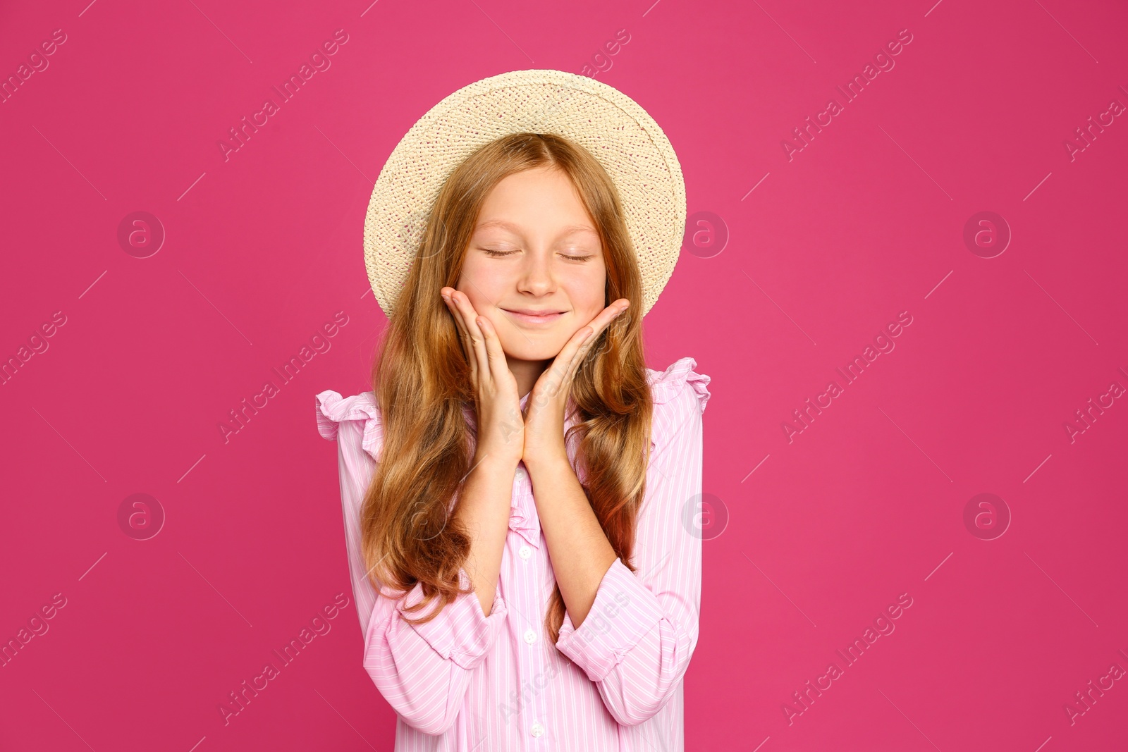 Photo of Portrait of preteen girl in hat on pink background