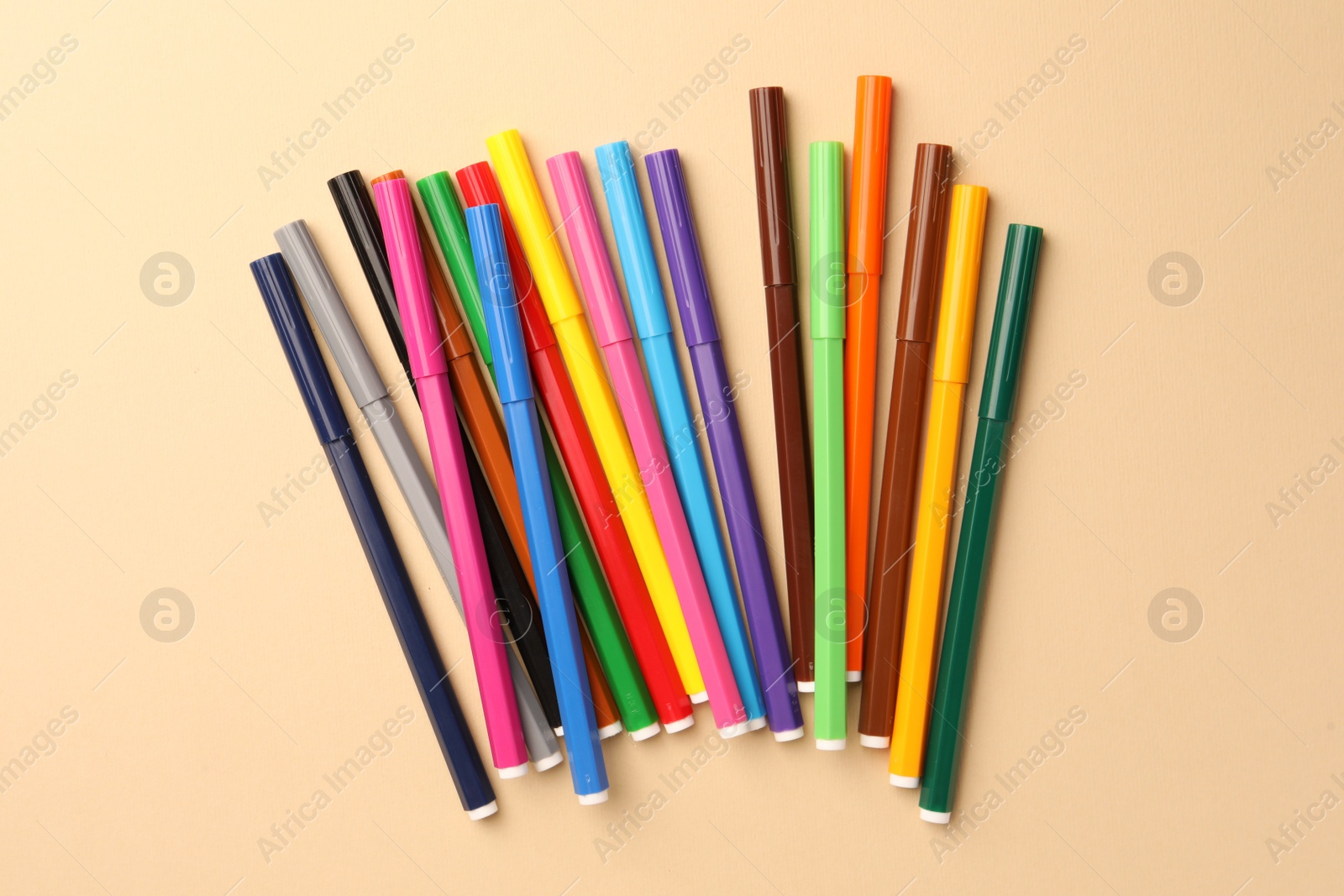 Photo of Many bright markers on beige background, flat lay