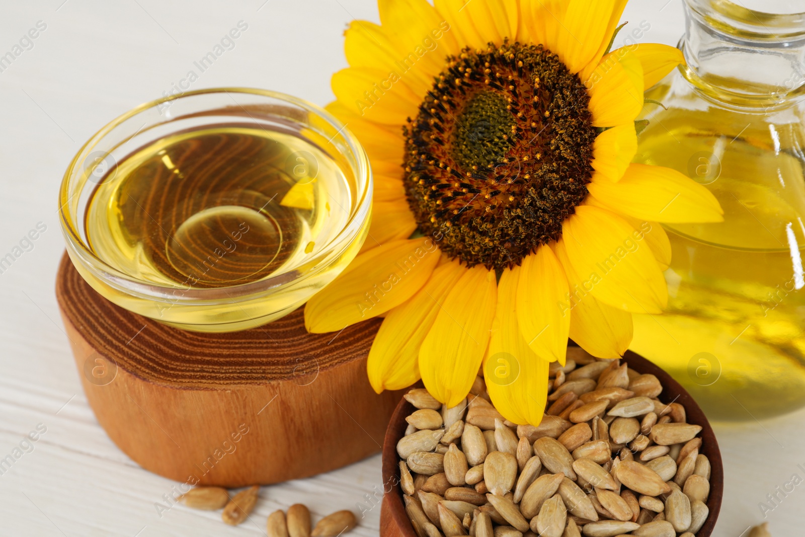 Photo of Composition with sunflower oil on white table, closeup