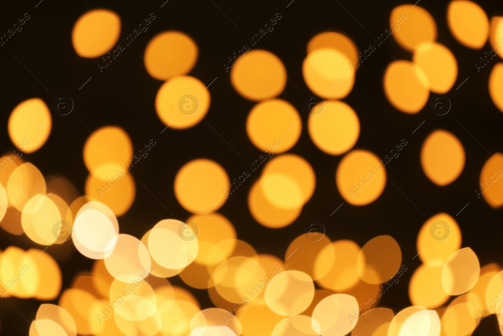 Photo of Beautiful golden lights on dark background. Bokeh effect