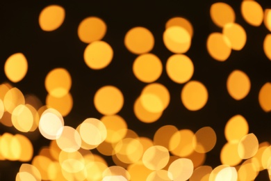 Photo of Beautiful golden lights on dark background. Bokeh effect