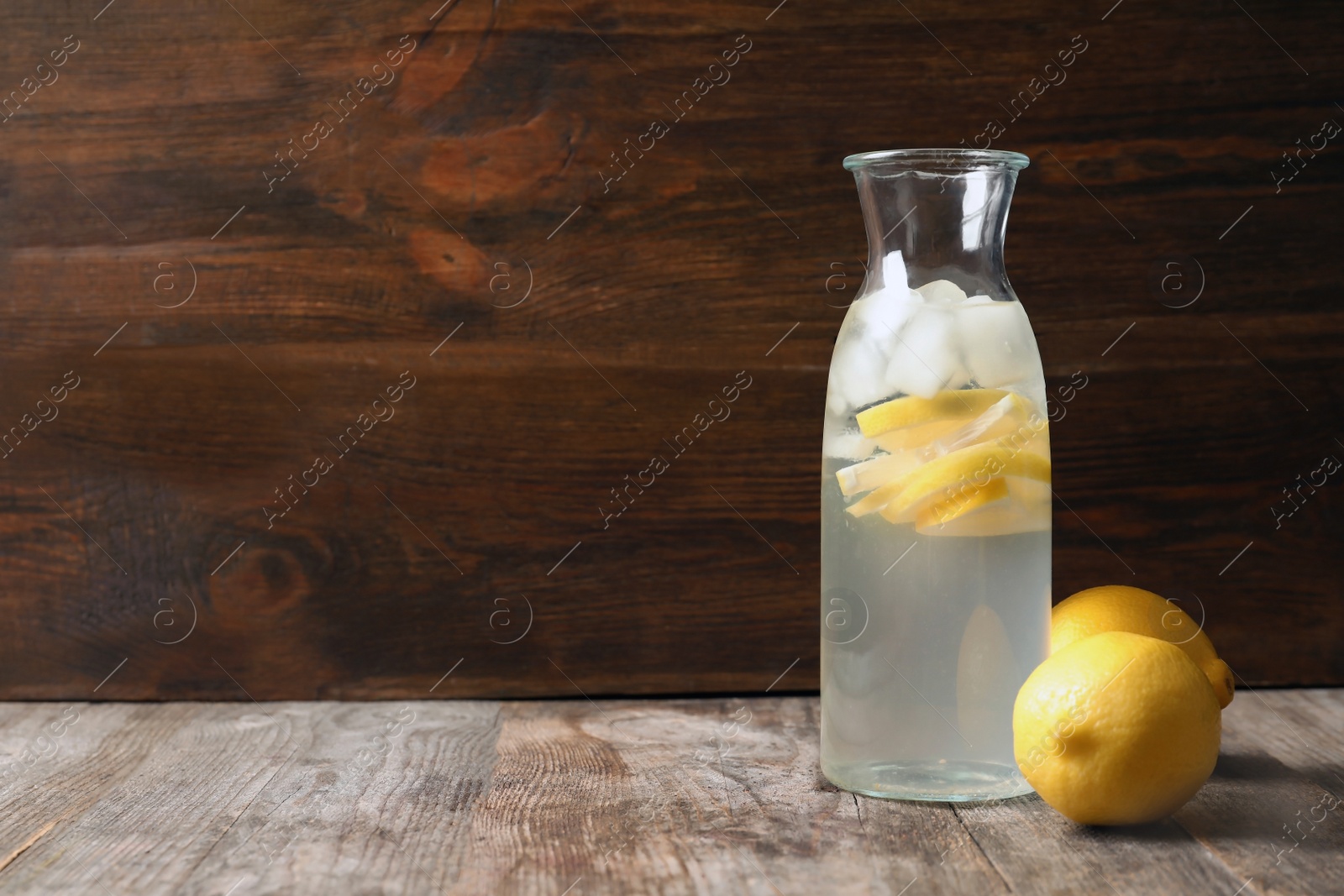 Photo of Natural lemonade in bottle on wooden table