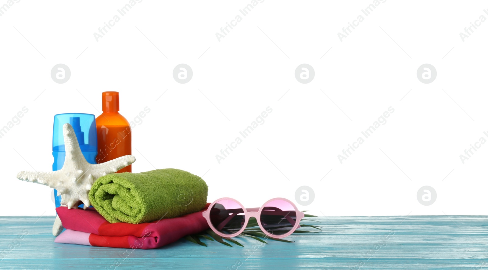 Photo of Set of different beach accessories on table against white background. Space for text