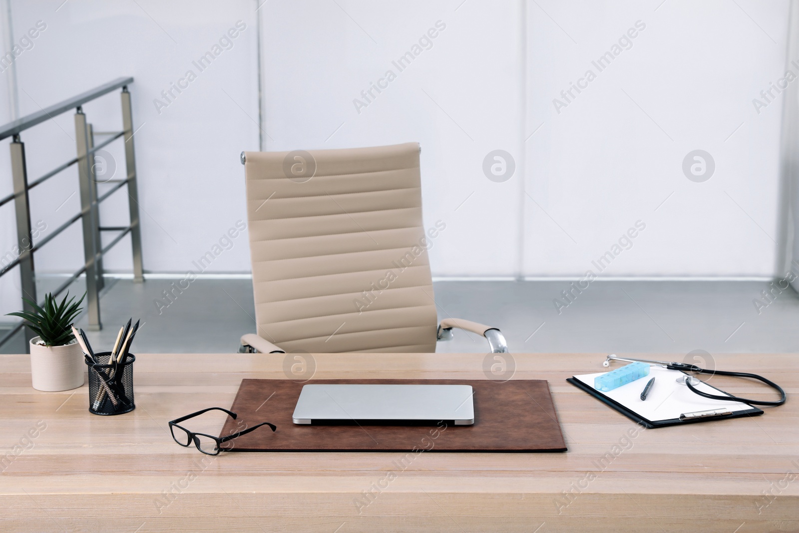 Photo of Modern doctor's workplace in office. Interior design