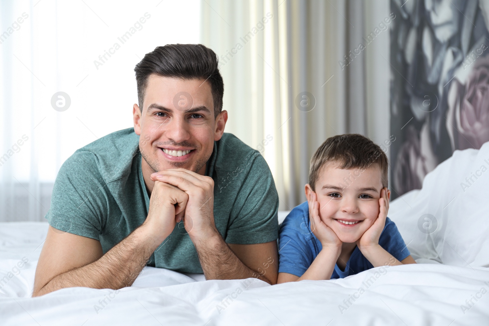 Photo of Dad and son spending time together at home. Happy Father's Day
