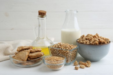 Photo of Different natural soy products on white wooden table