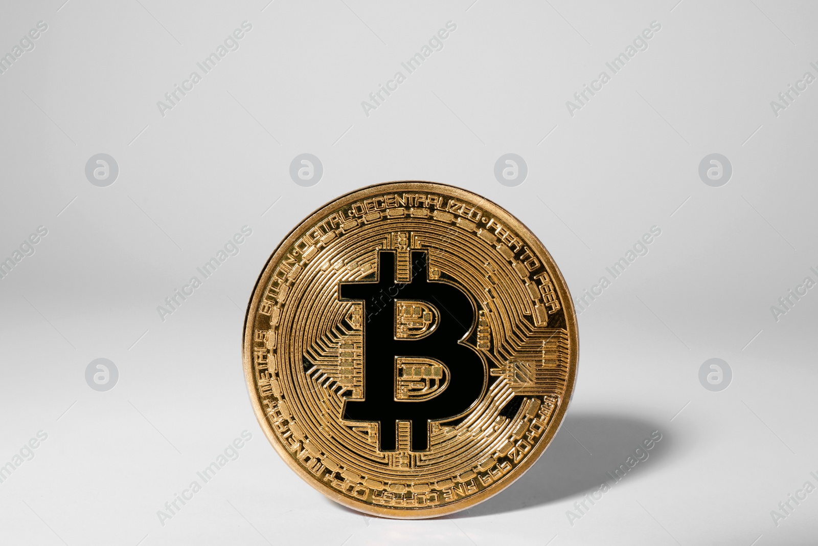 Photo of Shiny gold bitcoin on light background. Digital currency