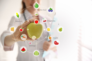 Image of Nutritionist's recommendations. Doctor with apple in office, closeup