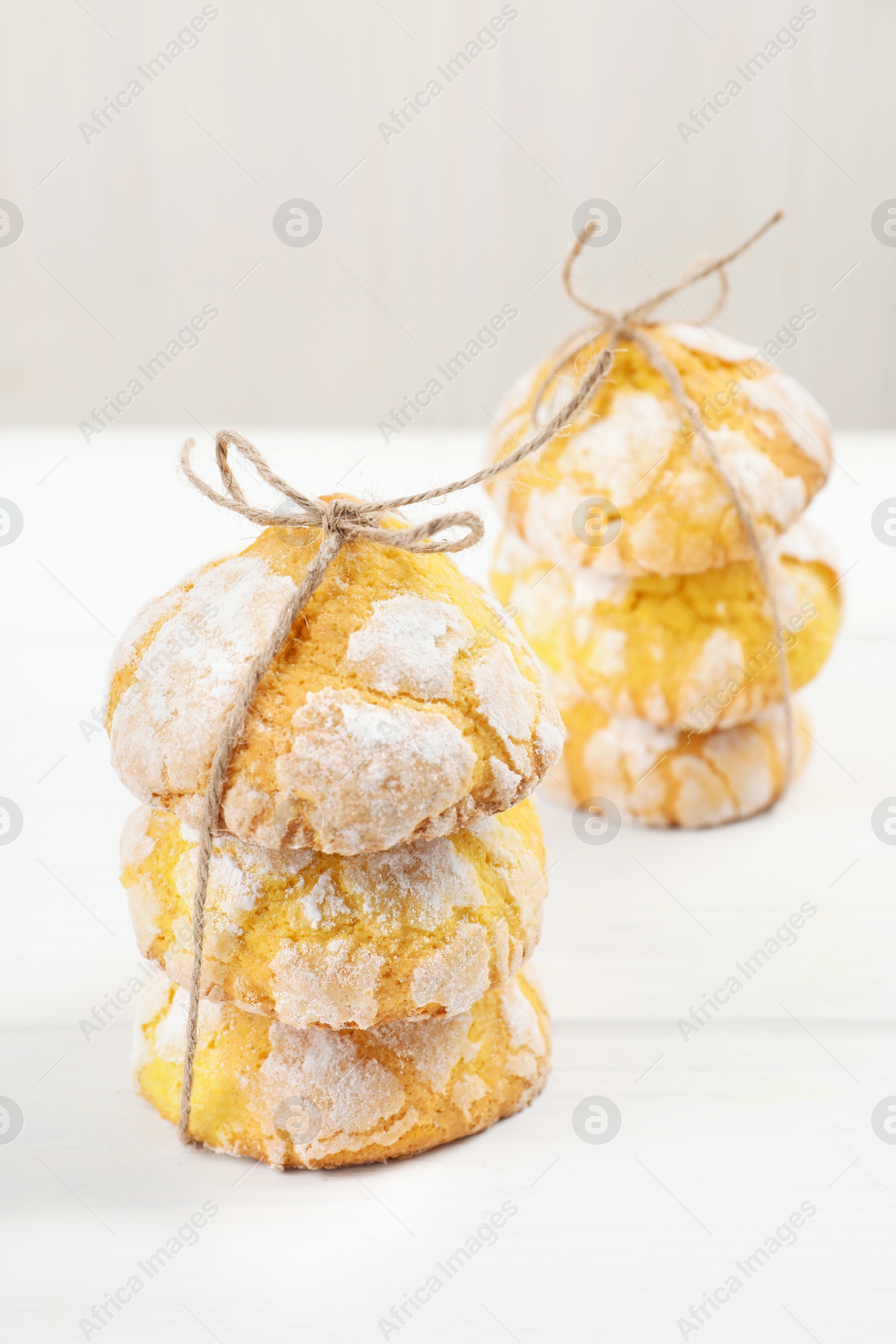 Photo of Tasty homemade lemon cookies on white wooden table