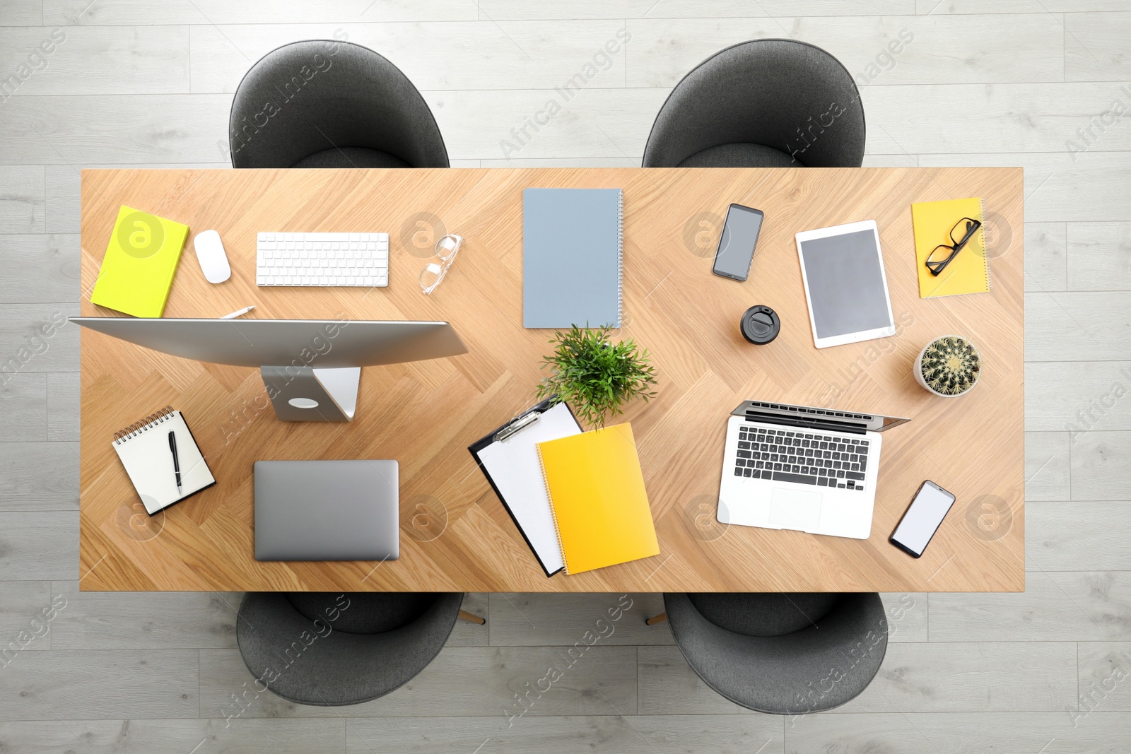 Photo of Modern office table with devices and chairs, top view