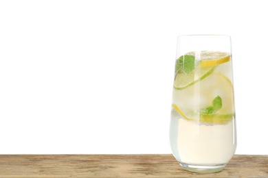 Glass of refreshing lemonade on wooden table against white background, space for text. Summer drink