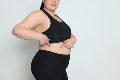 Photo of Obese woman on white background, closeup with space for text. Weight loss surgery