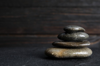 Stack of zen stones on table against blurred background. Space for text