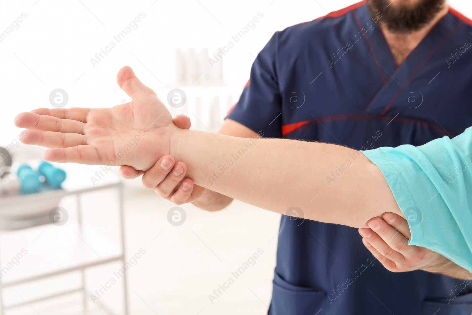 Photo of Young physiotherapist working with patient in clinic