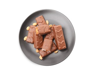 Photo of Plate of chocolate bars with caramel, nuts and nougat isolated on white, top view