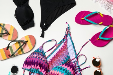 Photo of Flat lay composition with swimsuit and beach accessories on white background