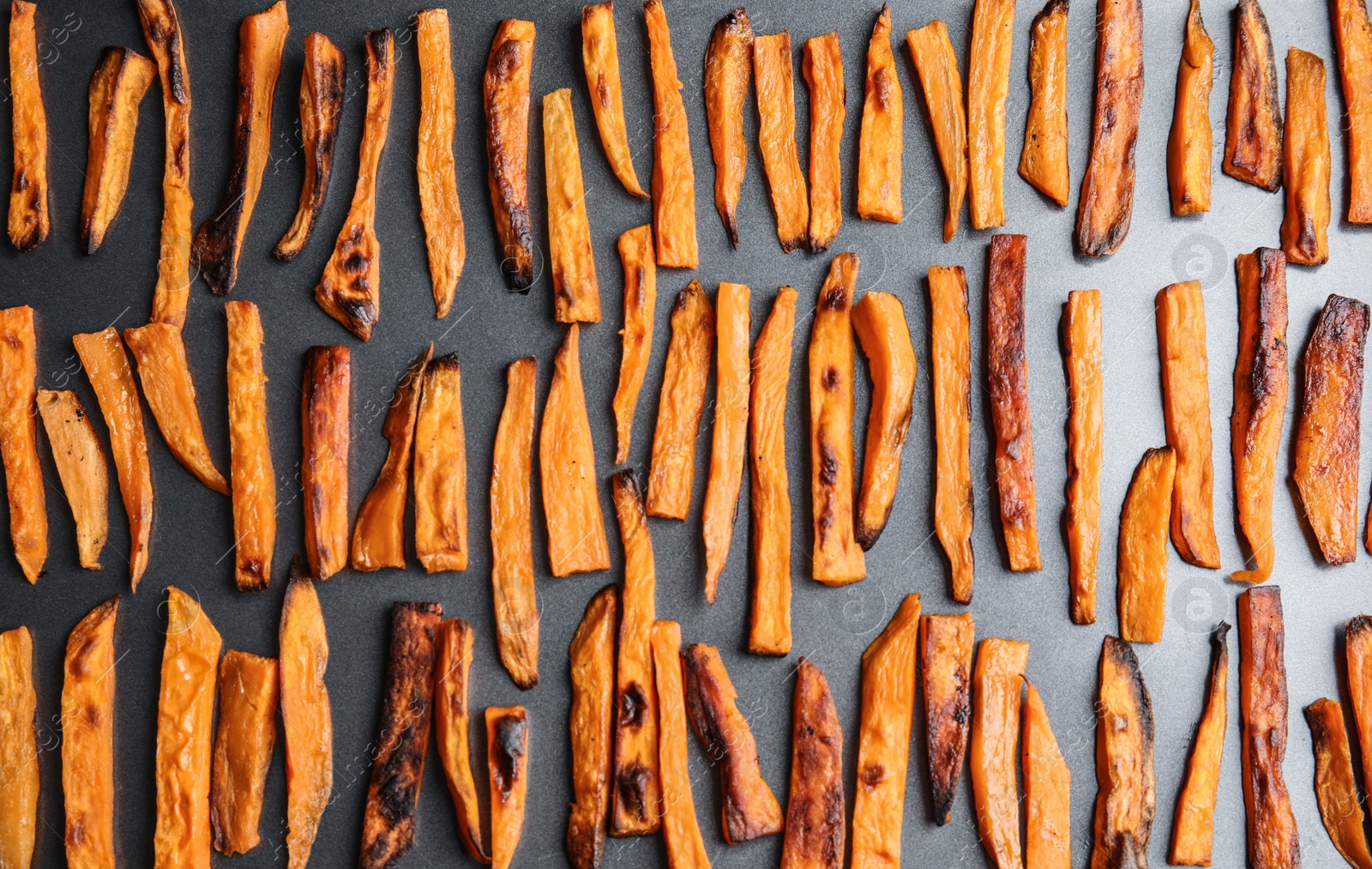 Photo of Baked sweet potato slices on grey background, flat lay