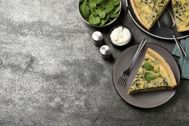 Photo of Piece of delicious spinach pie served on grey table, flat lay. space for text