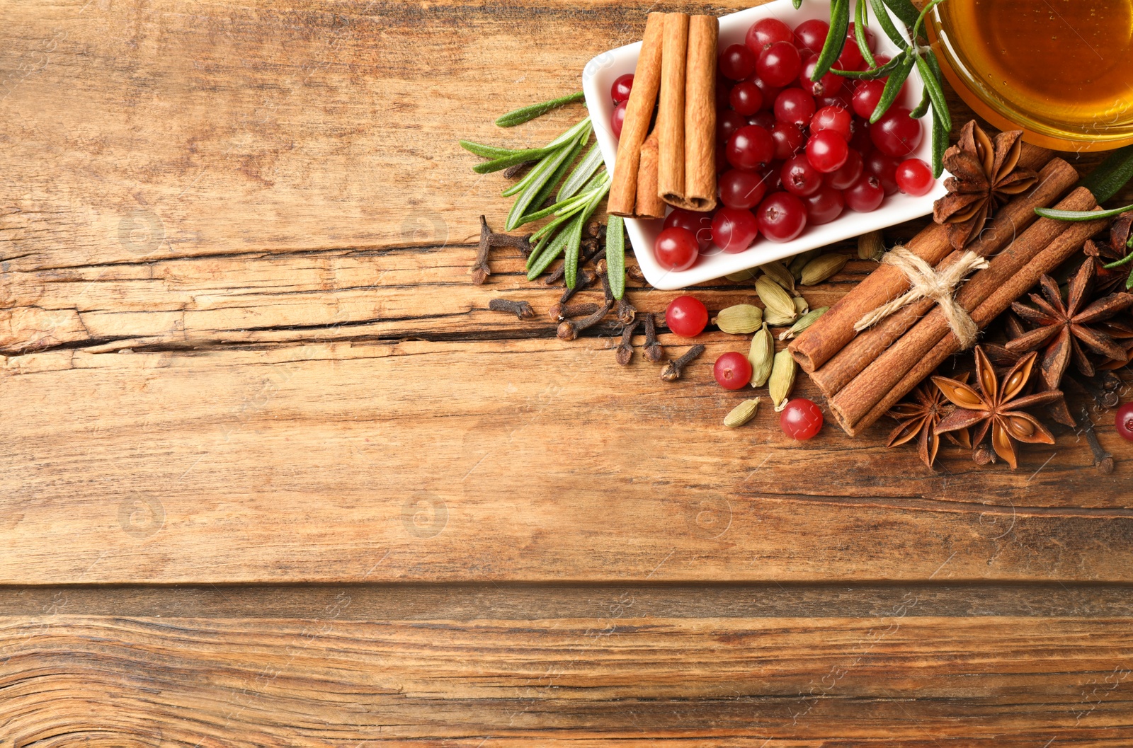 Photo of Flat lay composition with mulled wine ingredients on wooden table. Space for text