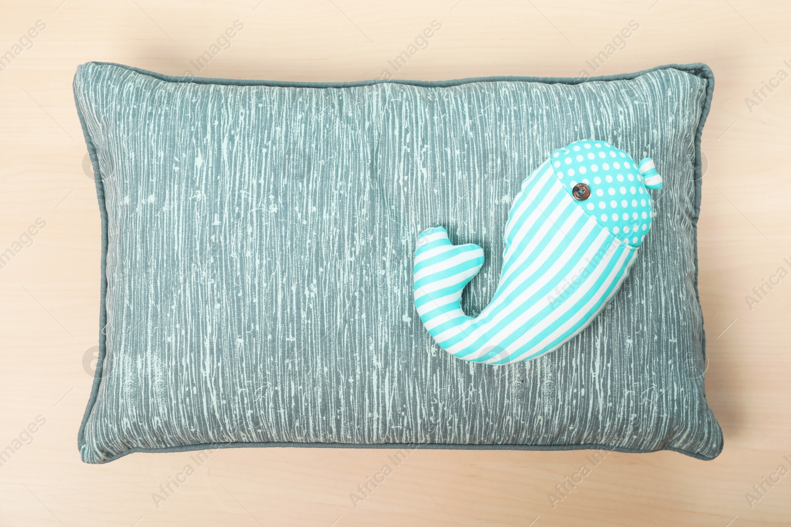 Photo of Soft decorative pillows on wooden background, top view