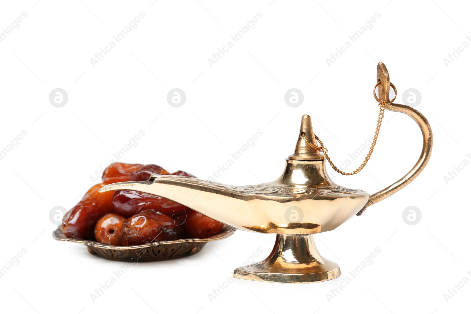 Photo of Aladdin magic lamp and dates on white background