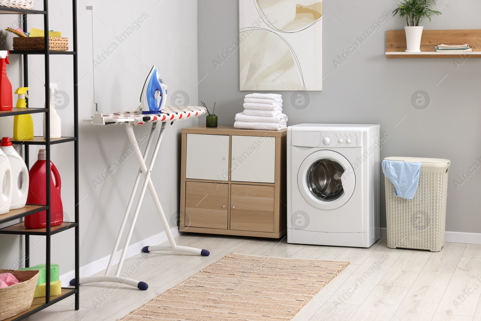 Photo of Laundry room interior with washing machine and furniture