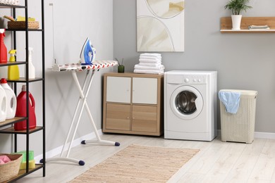 Laundry room interior with washing machine and furniture