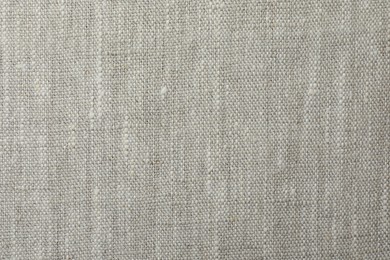 Photo of Texture of light grey fabric as background, top view