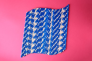 Photo of Many paper drinking straws on pink background, flat lay