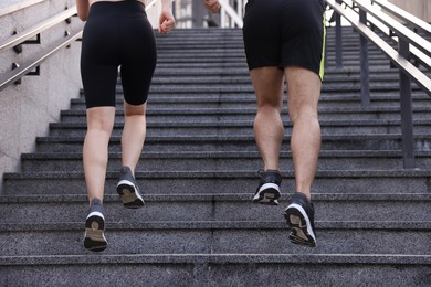 Photo of Healthy lifestyle. Couple running up steps outdoors, closeup