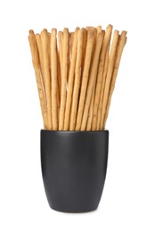 Delicious grissini sticks in cup on white background