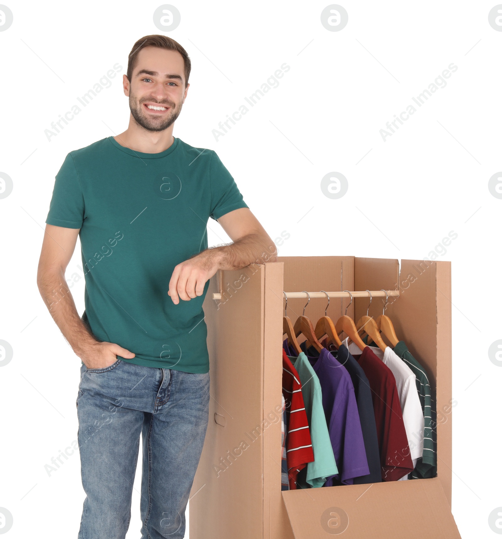 Photo of Young man near wardrobe box on white background