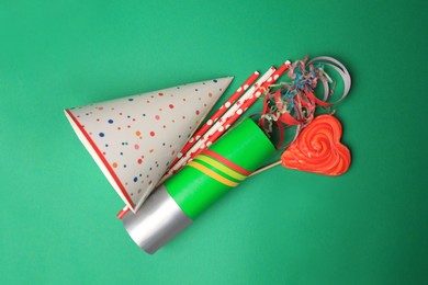 Many different party items on green background, flat lay