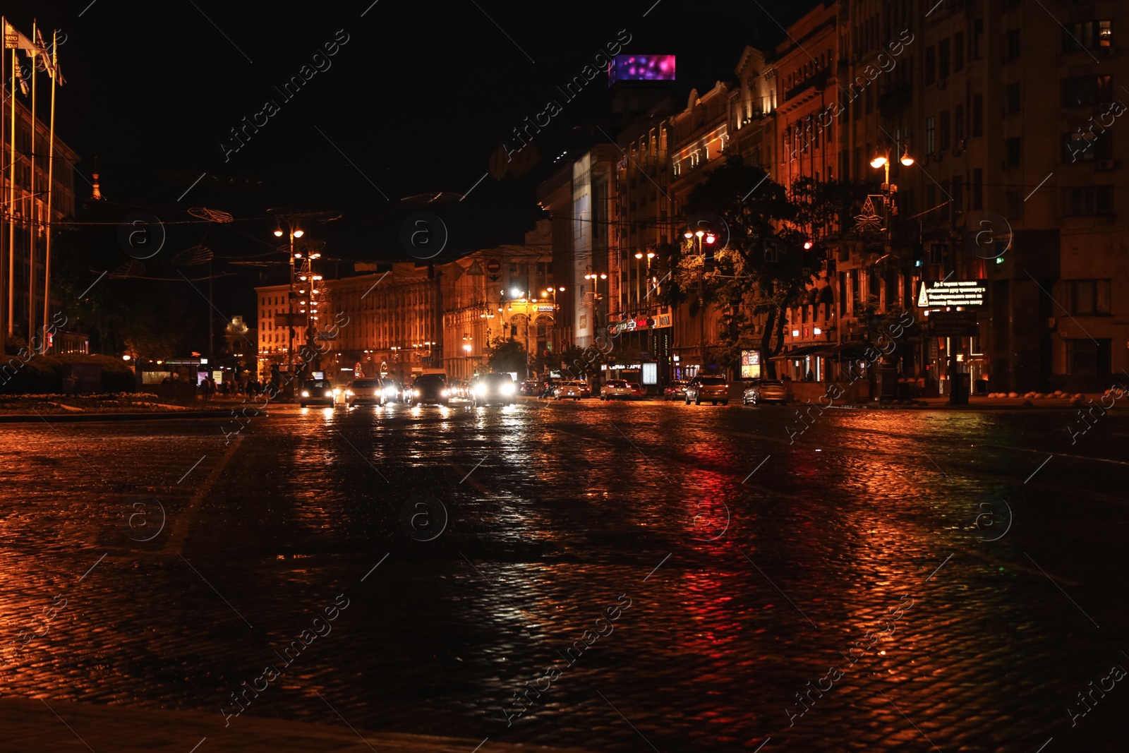 Photo of KYIV, UKRAINE - MAY 21, 2019: Night cityscape with illuminated buildings and street traffic