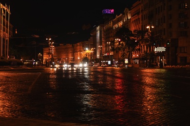 Photo of KYIV, UKRAINE - MAY 21, 2019: Night cityscape with illuminated buildings and street traffic