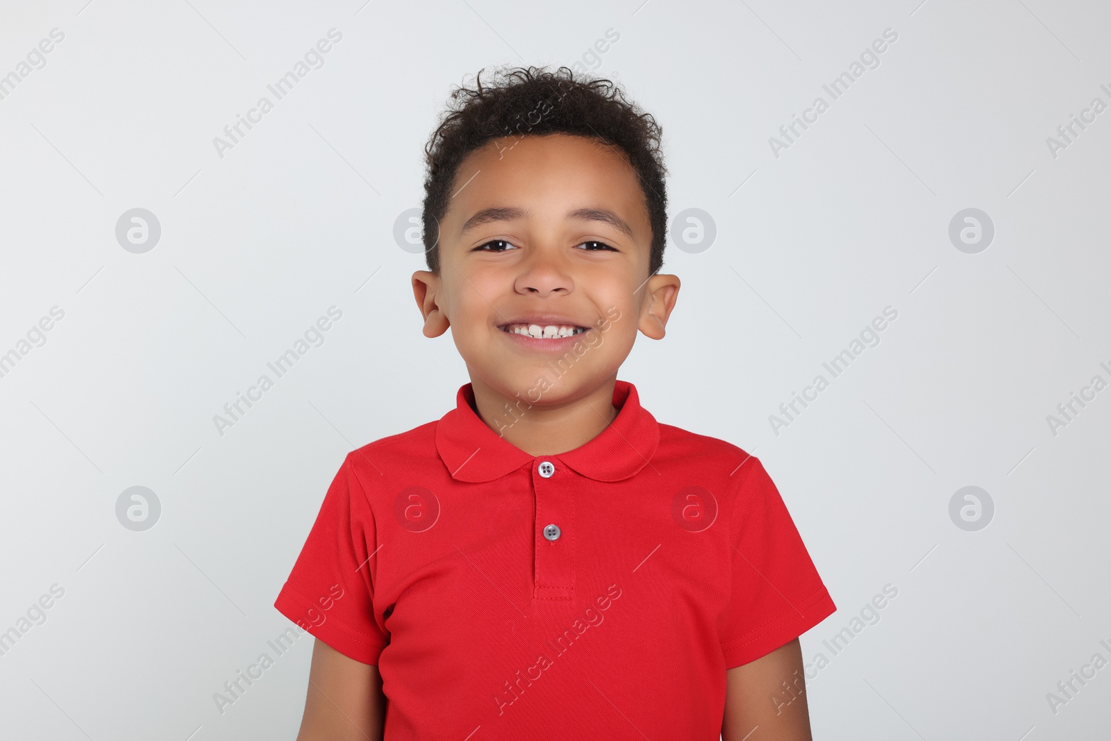 Photo of Portrait of cute African-American boy on light grey background
